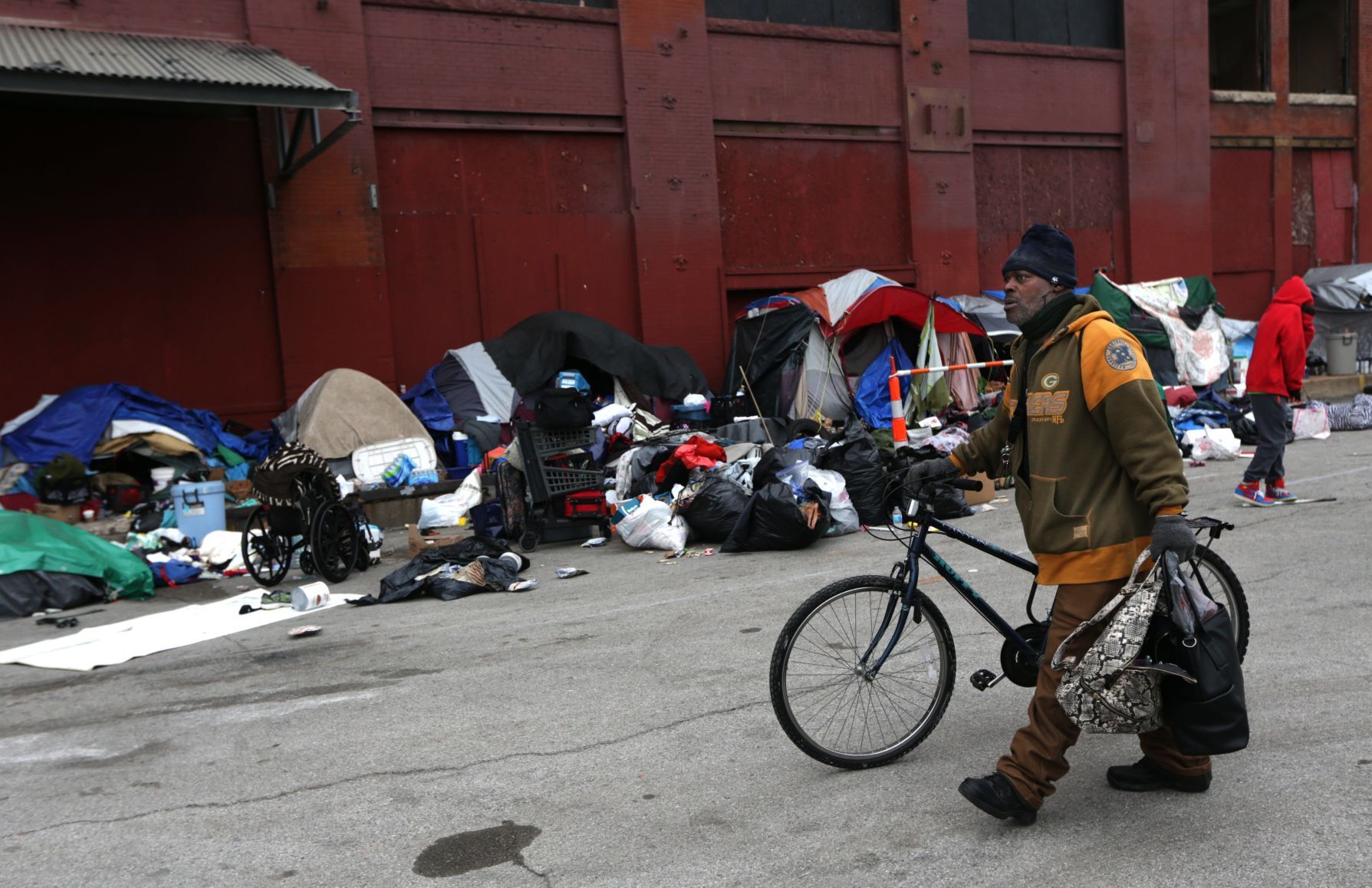 Tent encampment outside vacant McGuire Moving & Storage building